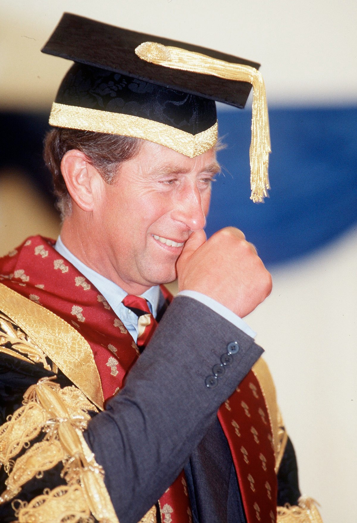 Then-Prince Charles scracthing his nose during a graduation ceremony at The Royal Agricultural College