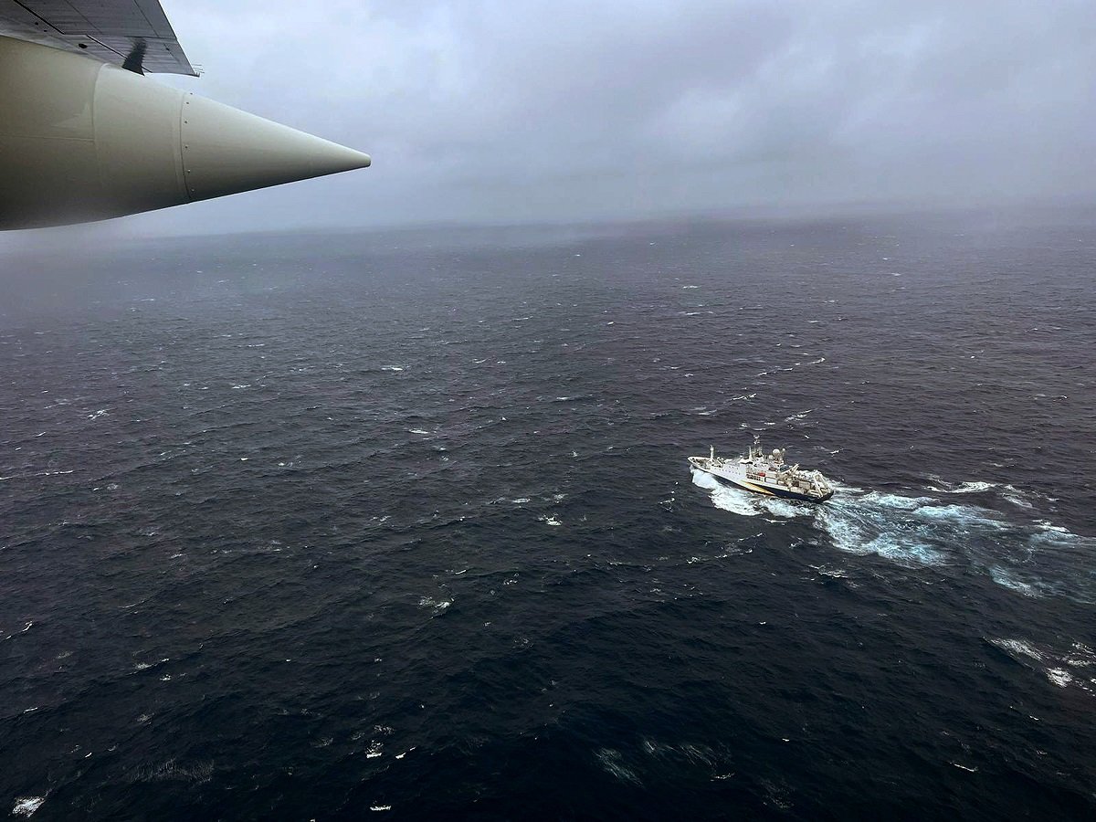 The U.S. Coast Guard Hercules Airplane flies oveheard durignt he search for the missing Titan Submersible