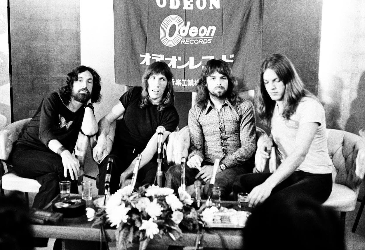 Pink Floyd members (from left) Nick Mason, Roger Waters, Richard Wright, and David Gilmour sitting on a couch during a 1971 press conference in Japan.