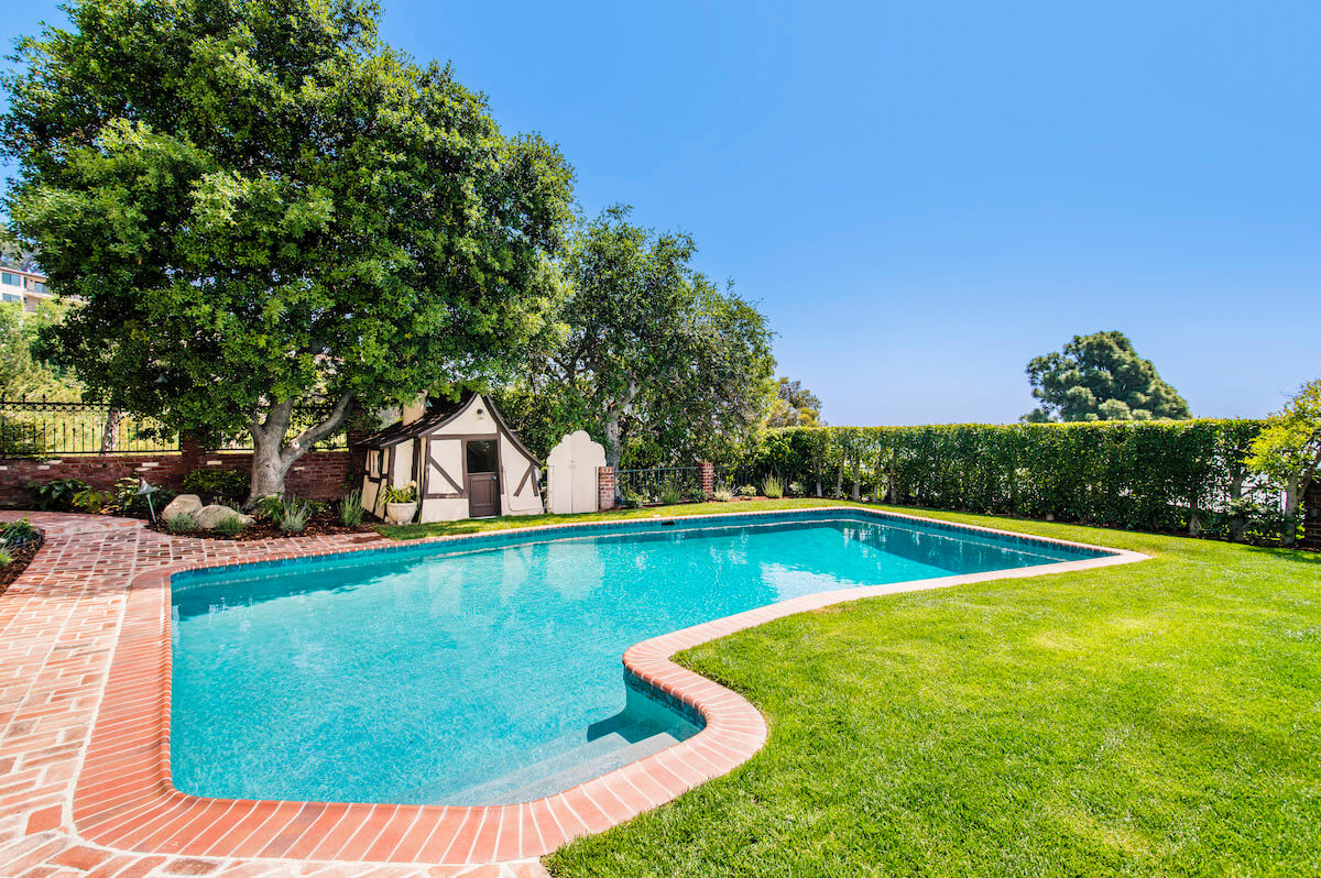 Backyard pool with storybook playhouse