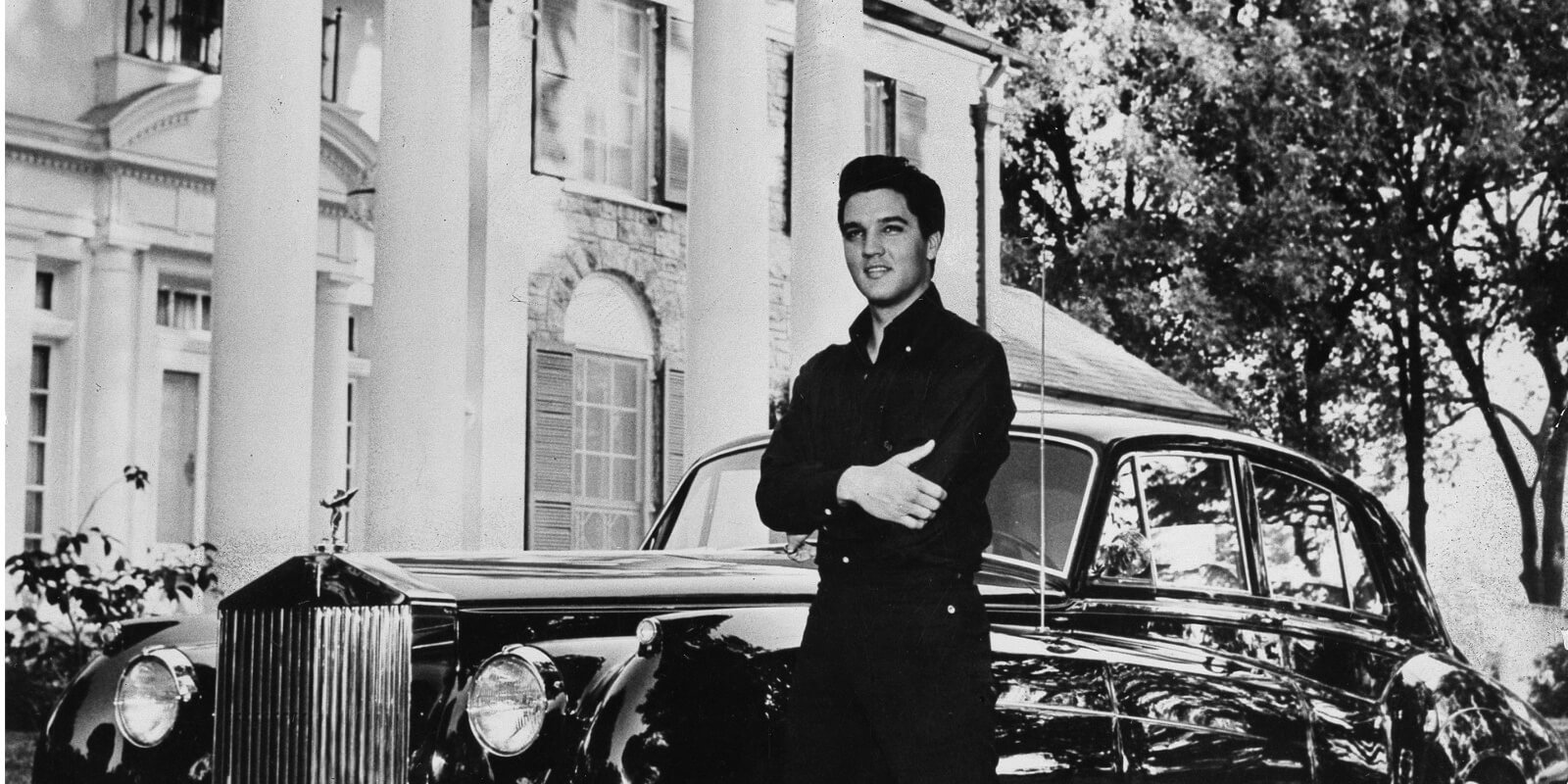 Elvis Presley stands outside of his home, Graceland, located in Memphis, TN.