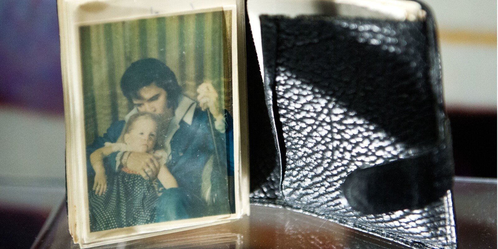 Elvis Presley's wallet contained a photograph of he and Lisa Marie Presley.