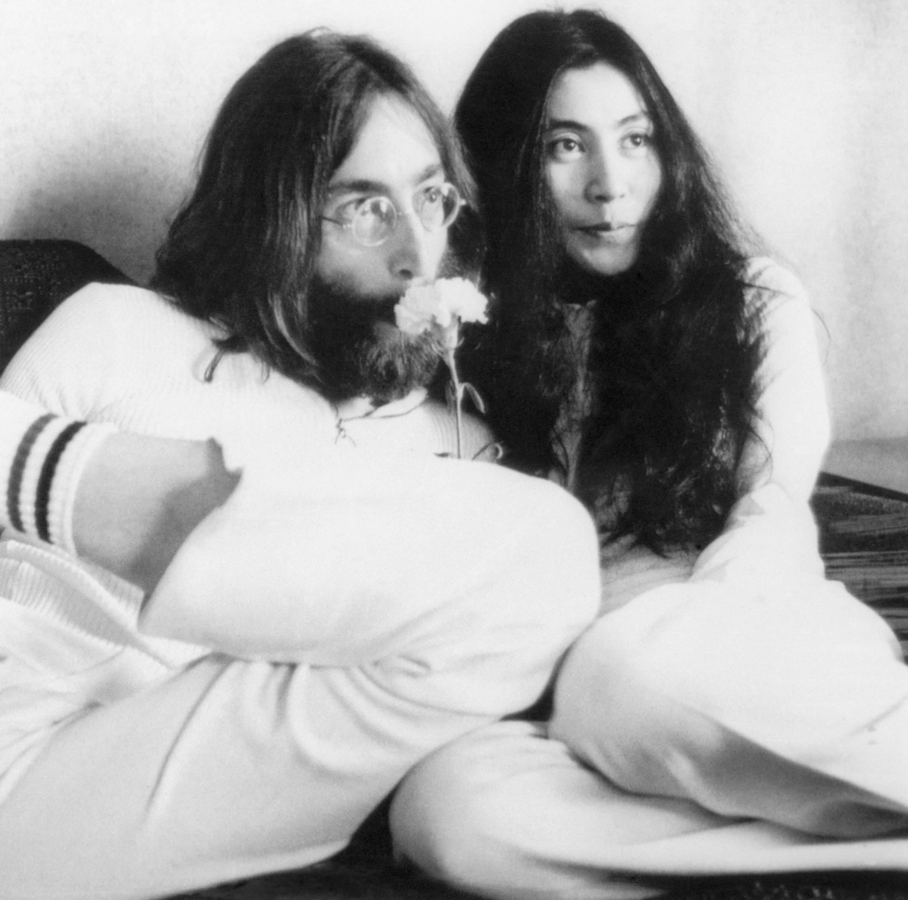 John Lennon and Yoko Ono with a flower