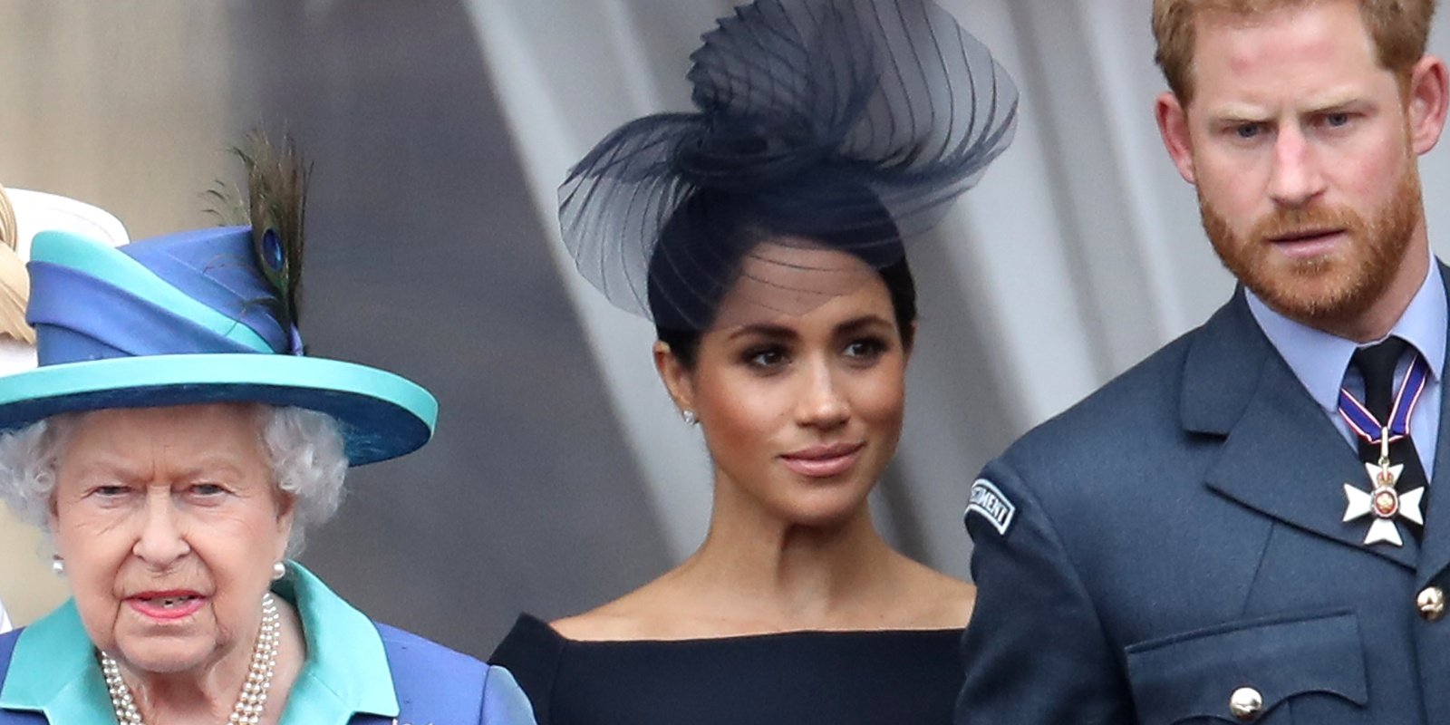 Queen Elizabeth, Meghan Markle, and Prince Harry appear on the Buckingham Palace balcony in 2018.