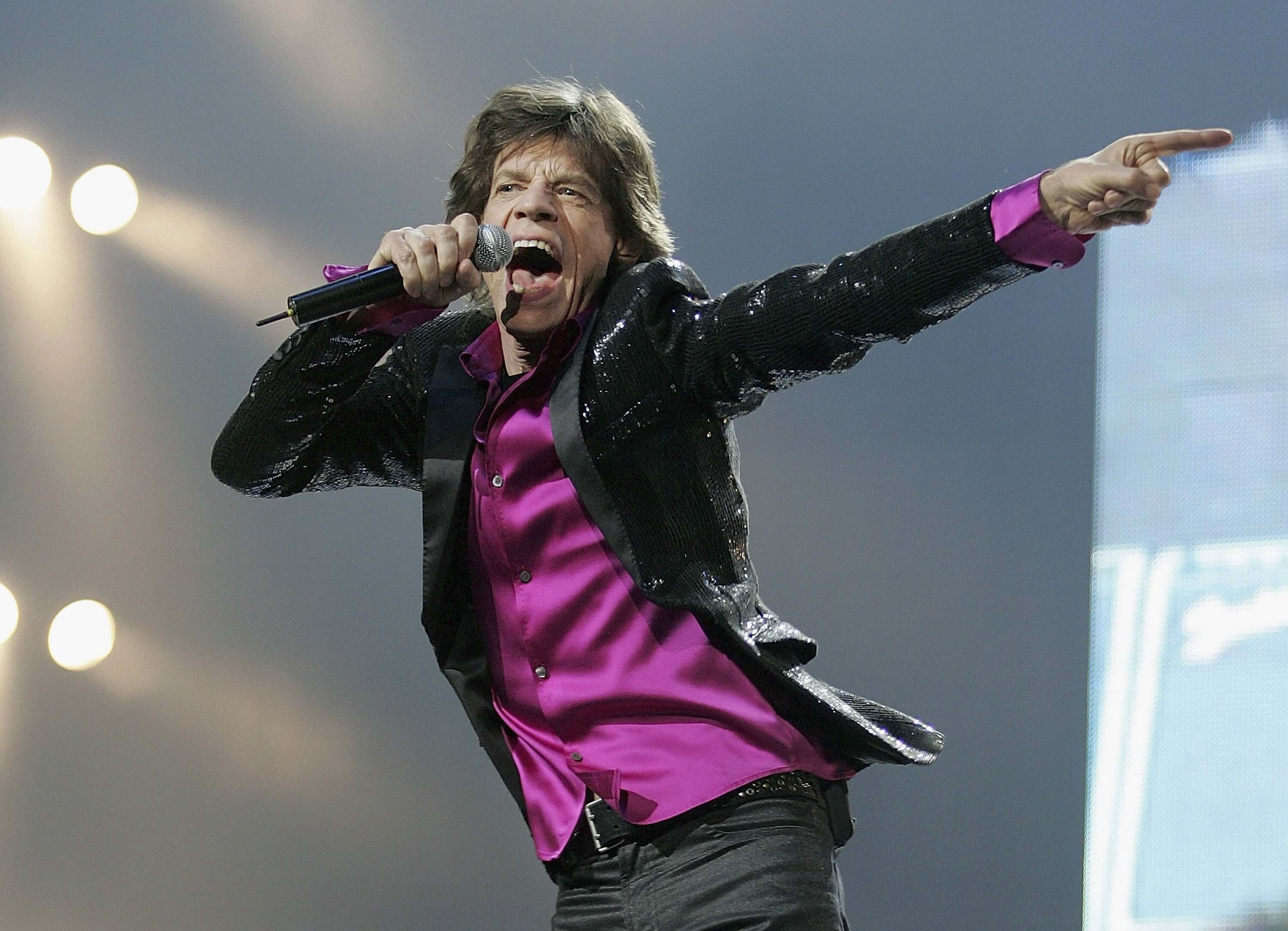 The Rolling Stones' Mick Jagger wearing purple