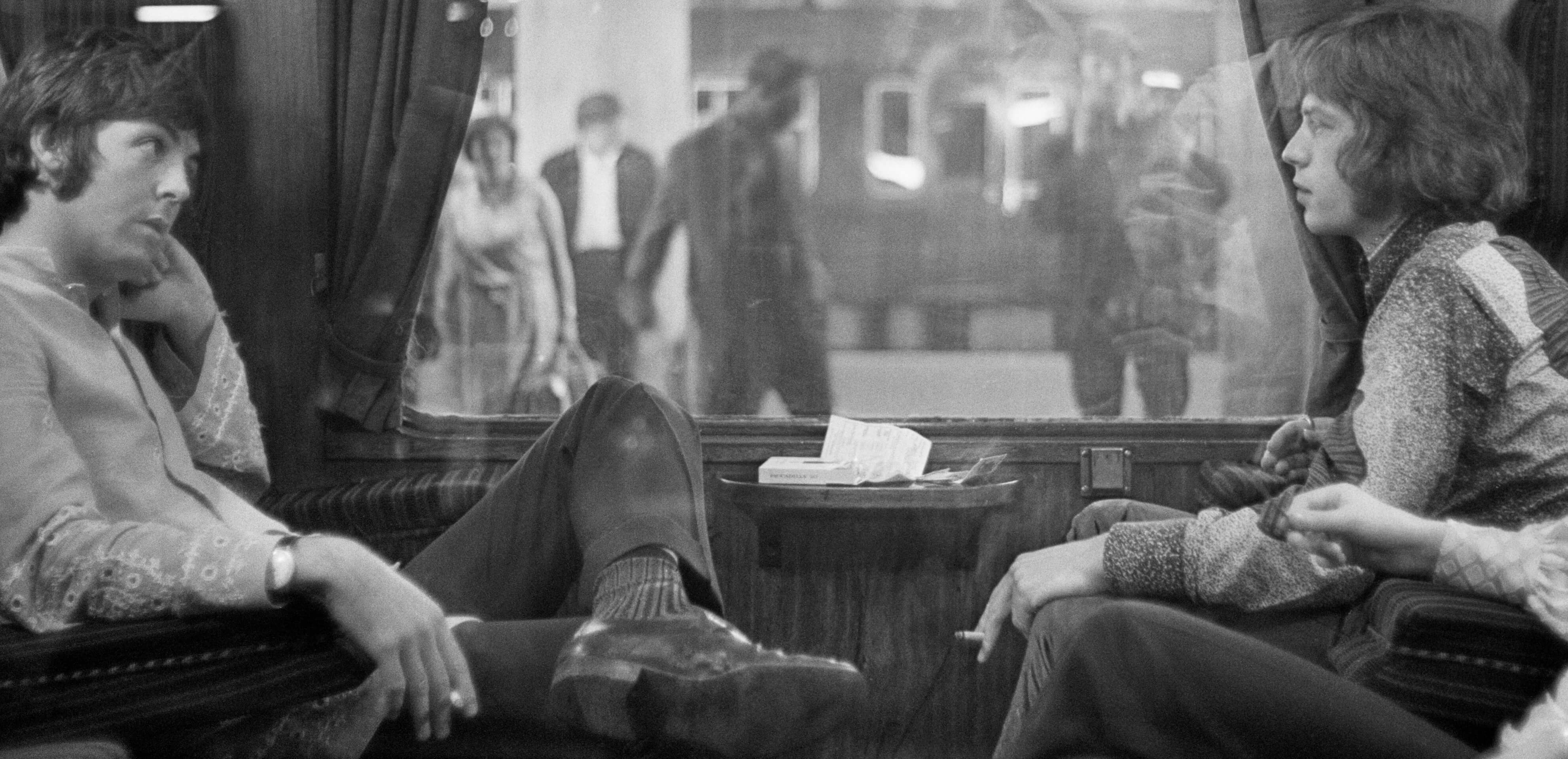 Paul McCartney and Mick Jagger in a train car