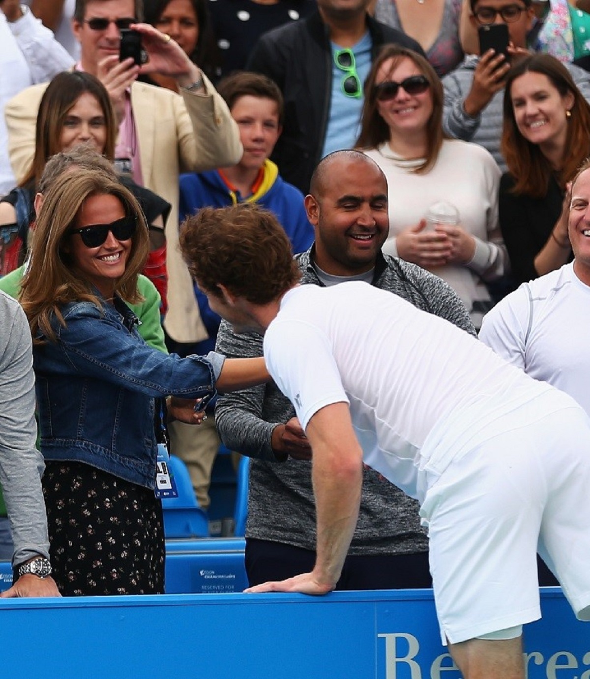 Andy Murray reaches out to his wife Kim Murray after a victory match