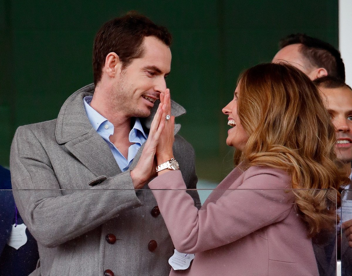 Andy Murray, who pays tribute to his wife Kim during matches by tying his wedding ring to his shoelaces, attends day 2 'Ladies Day' of the Cheltenham Festival in England