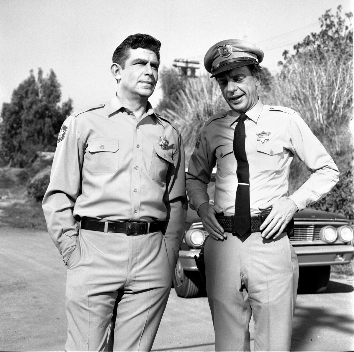 Andy Taylor and Barney Fife stand together in Mayberry