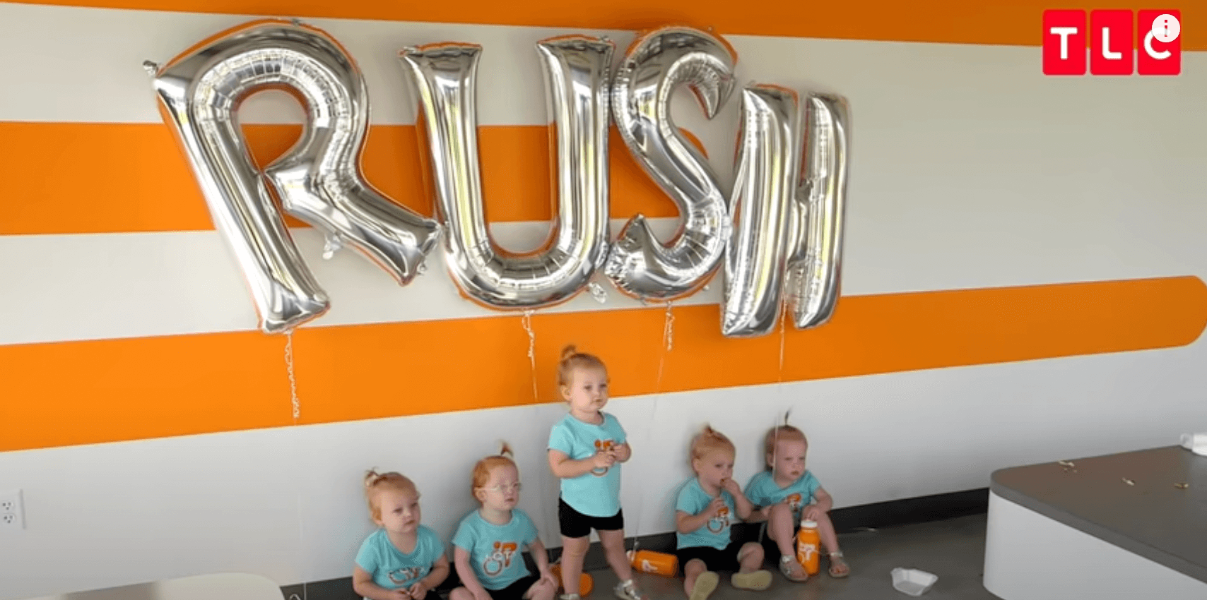 The Busby Quints posing for a photo in the family's cycling studio in 'OutDaughtered'