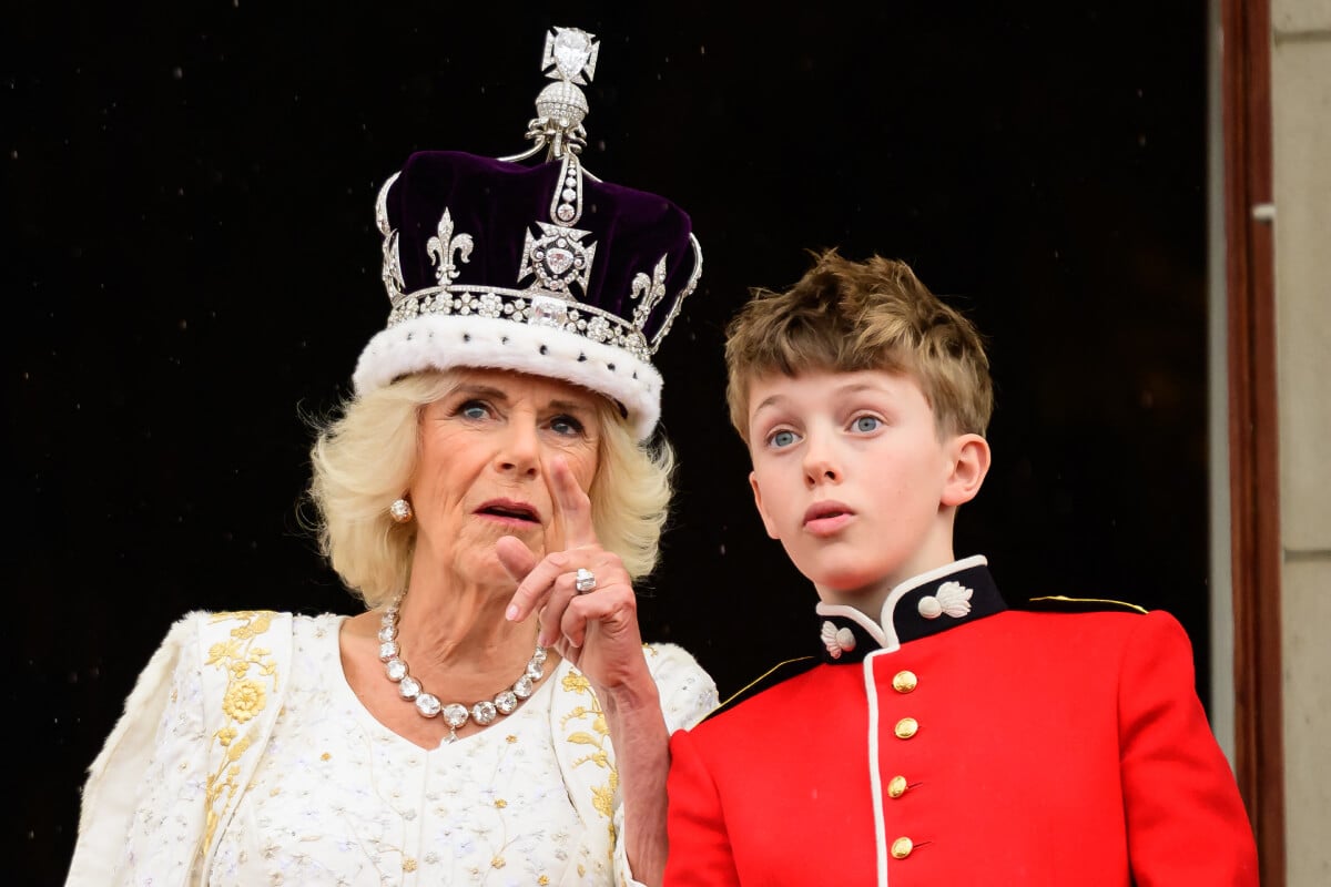 Queen Camilla talks to her grandson Freddy Parker Bowles on the Buckingham Palace balcony , in London, following her coronation, on May 6, 2023