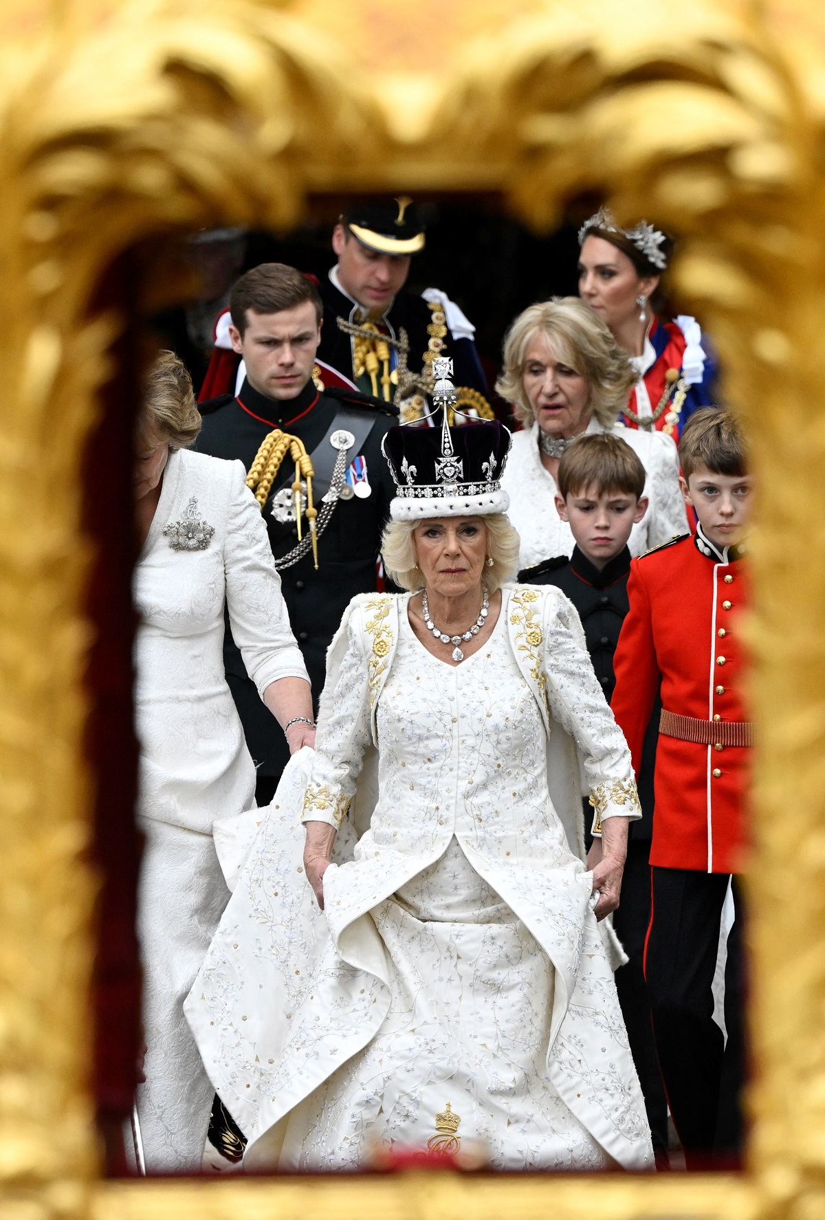Camilla Parker Bowles (now-Queen Camilla) leaving her coronation ceremony at Westminster Abbey followed by Prince William, Kate Middleton, and others