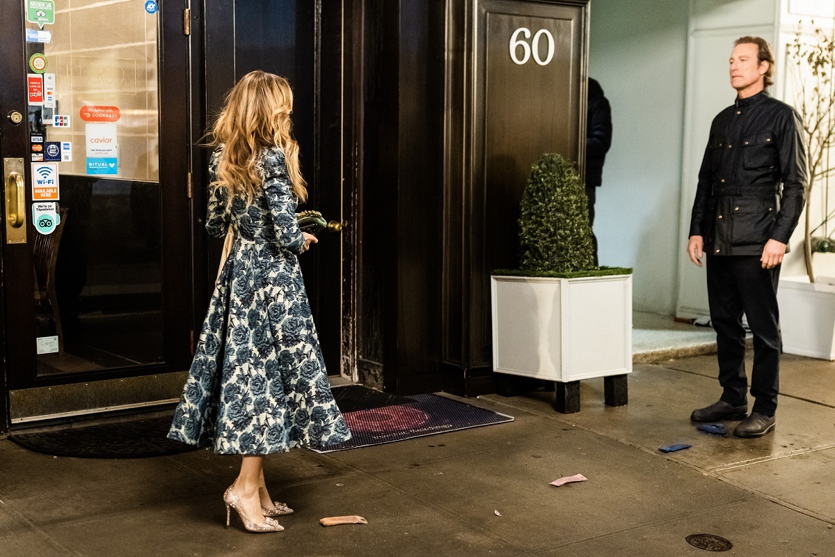 Sarah Jessica Parker as Carrie Bradshaw approaches John Corbett as Aidan Shaw in an episode of 'And Just Like That...' season 2
