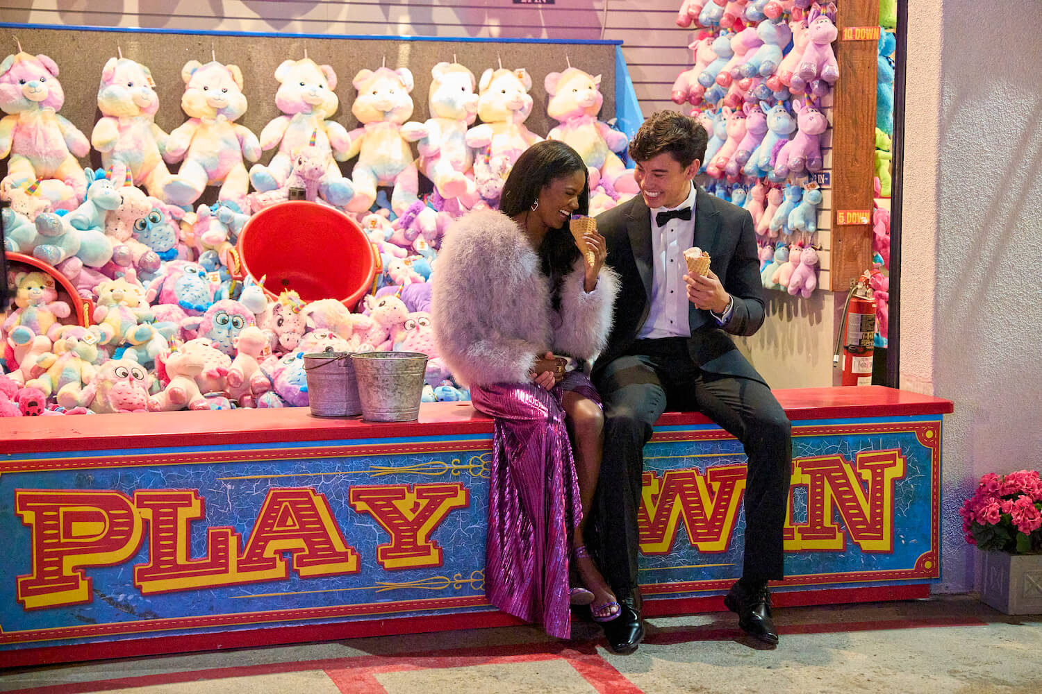Charity Lawson and Warwick Reider eating ice cream in an amusement park in 'The Bachelorette' 2023 episode 3