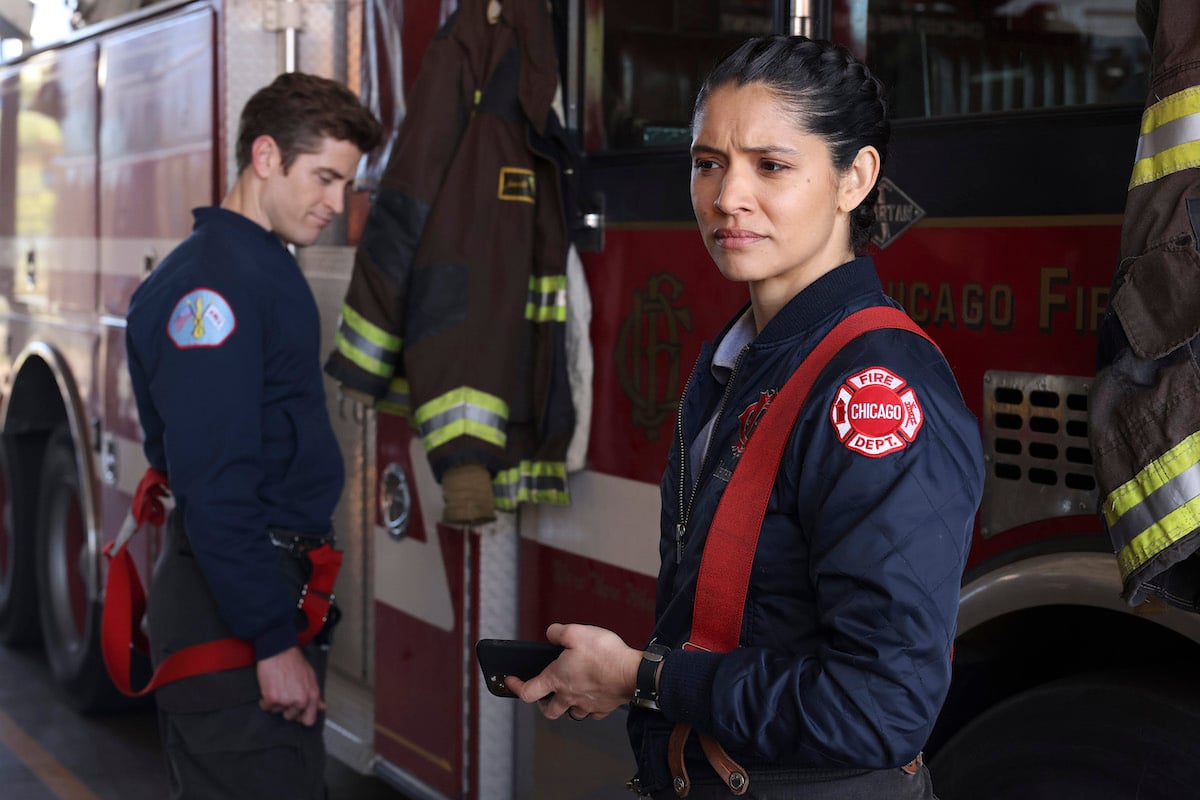 Stella Kidd standing in front of a fire truck with Carver behind her in 'Chicago Fire' Season 11