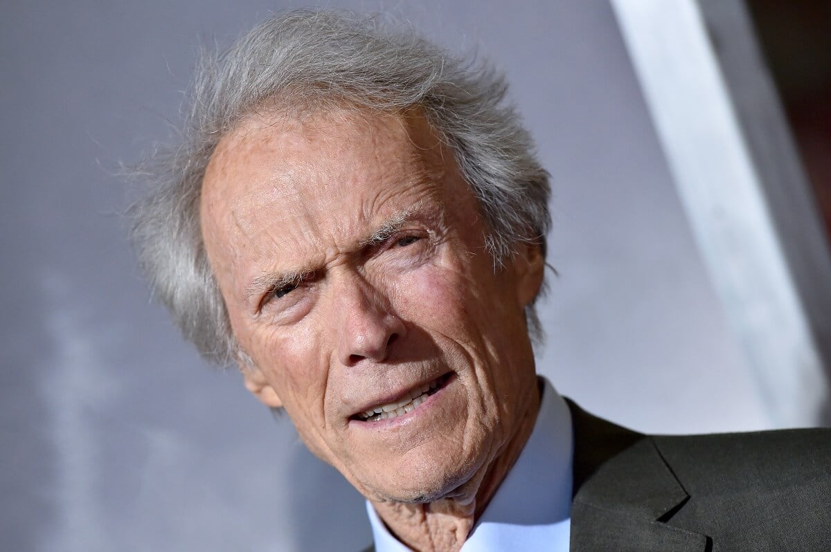 Clint Eastwood posing in a suit at the premiere of 'The Mule'.