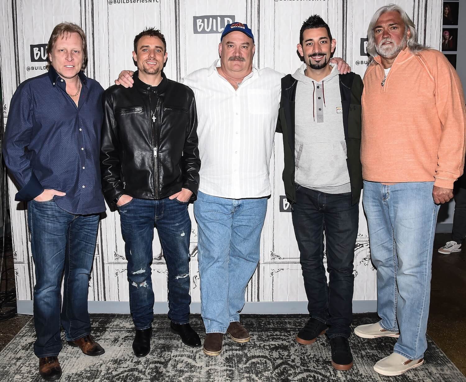 'Deadliest Catch' cast members, including Jake Anderson, standing together with their arms around each other and smiling