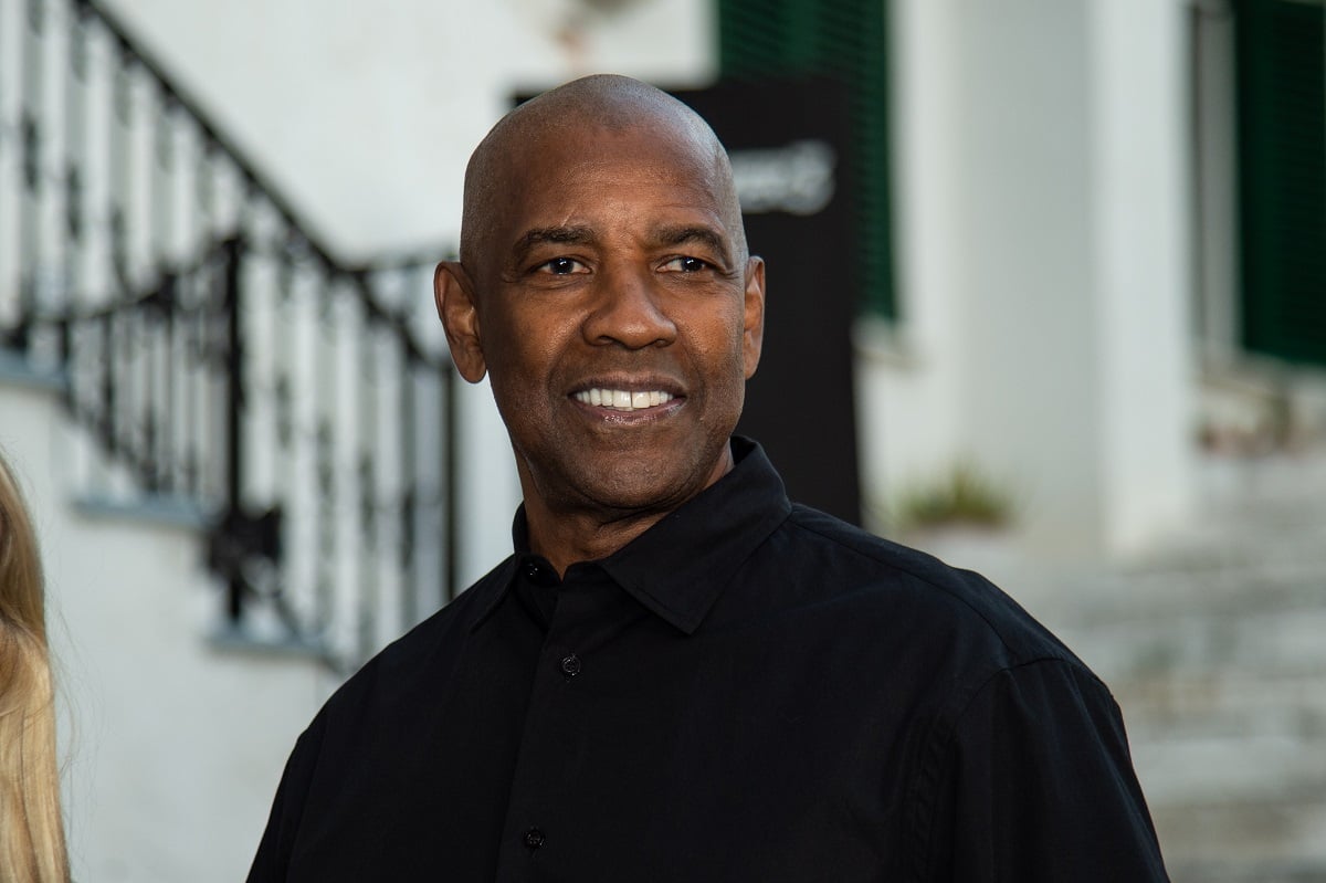 Denzel Washington posing while wearing a black shirt at a photocall for the film 'Equalizer 3'.