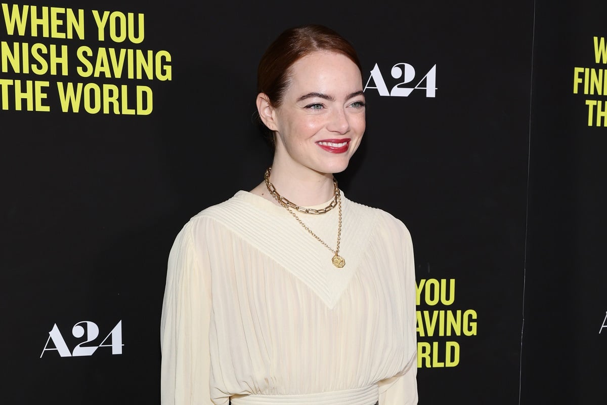 Emma Stone wearing a white outfit while posing in a screening of 'When You Finish Saving the World'.