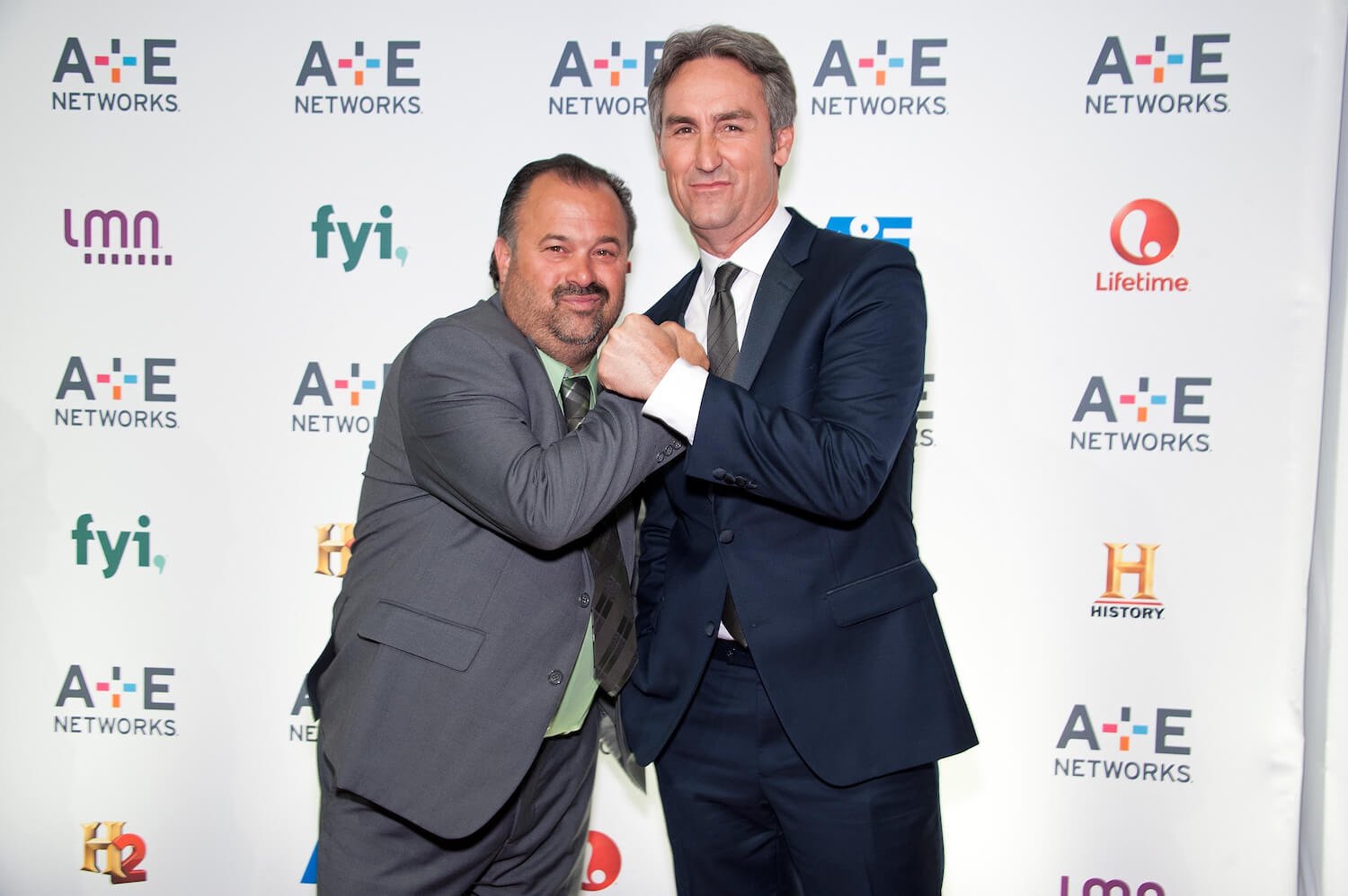 Frank Fritz and Mike Wolfe from 'American Pickers' in suits and ties at an event