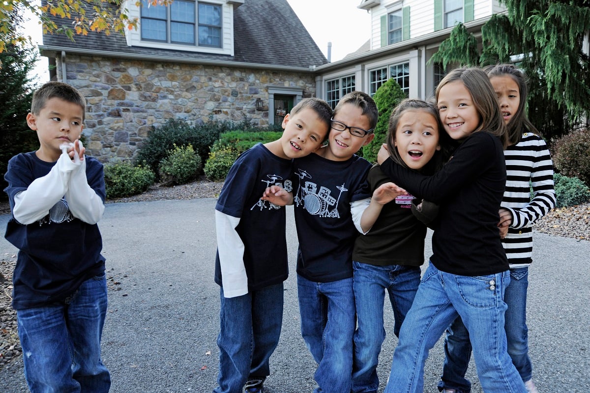 Collin Gosselin stands off to the side, while his siblings, Joel, Aaden, Leah, Alexis and Hannah Gosselin embrace in front of the family's Pennsylvania home.