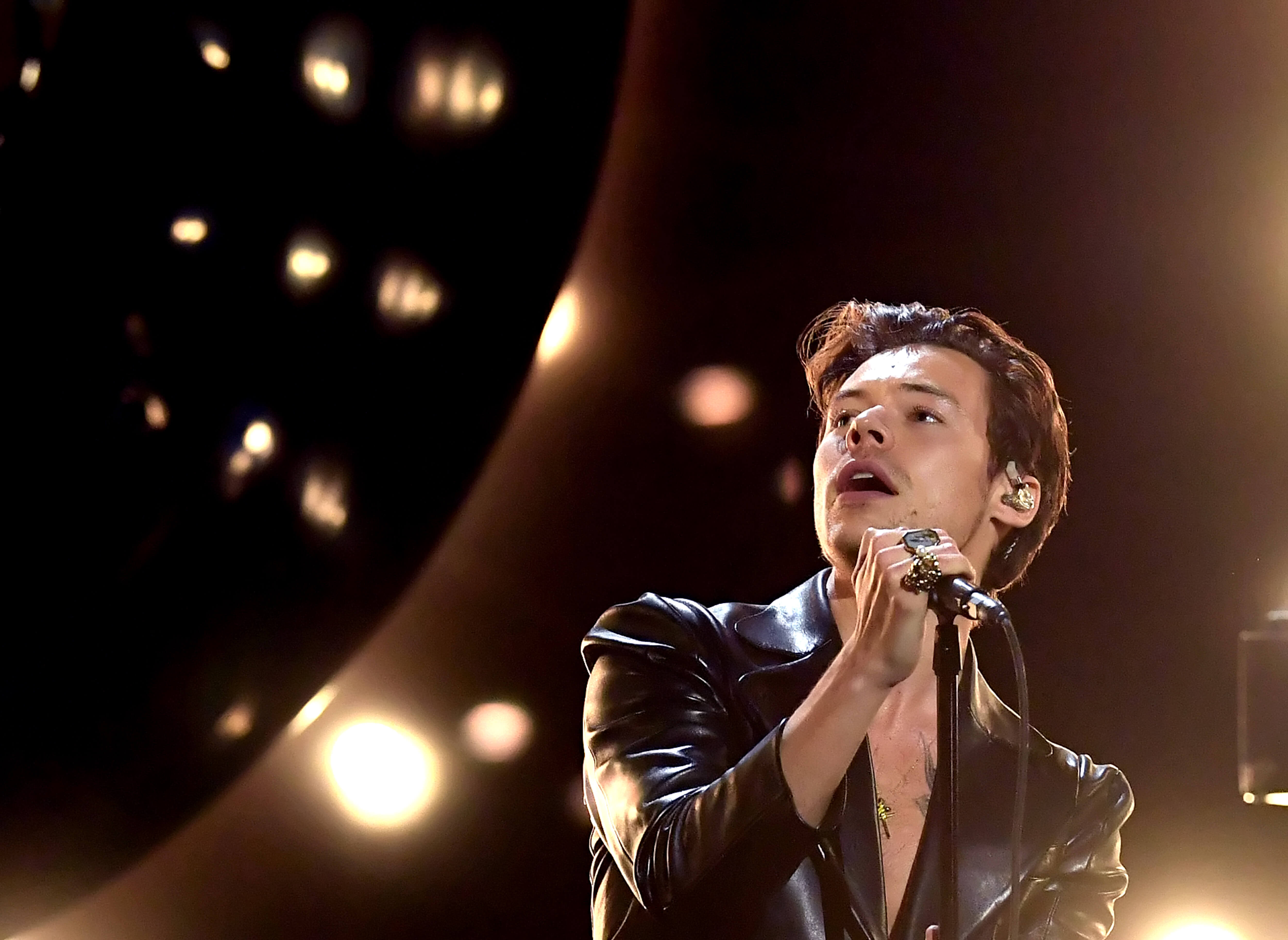 Harry Styles singing on stage.