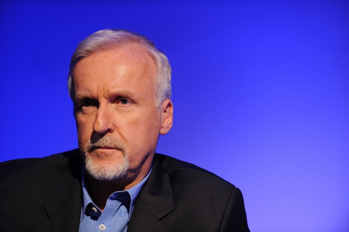 James Cameron taking a picture in a black blazer at a 'Meet the Filmmaker' event in New York.