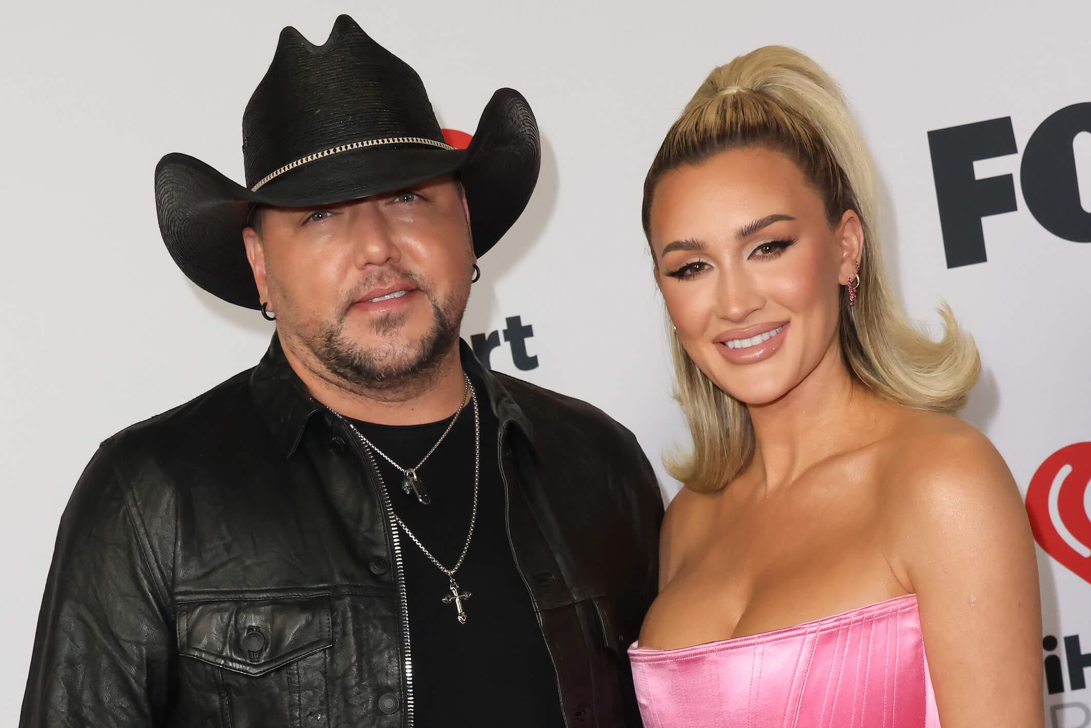 Jason Aldean and his wife, Brittany Aldean, standing next to each other at an event
