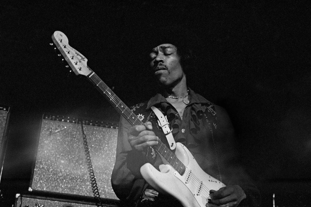 Jimi Hendrix playing guitar.