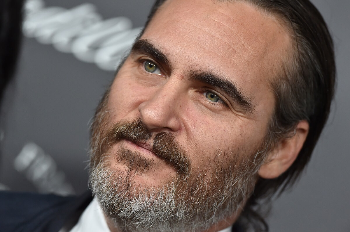Joaquin Phoenix taking a picture in a suit at the The Art of Elysium's 11th Annual Celebration - Heaven.