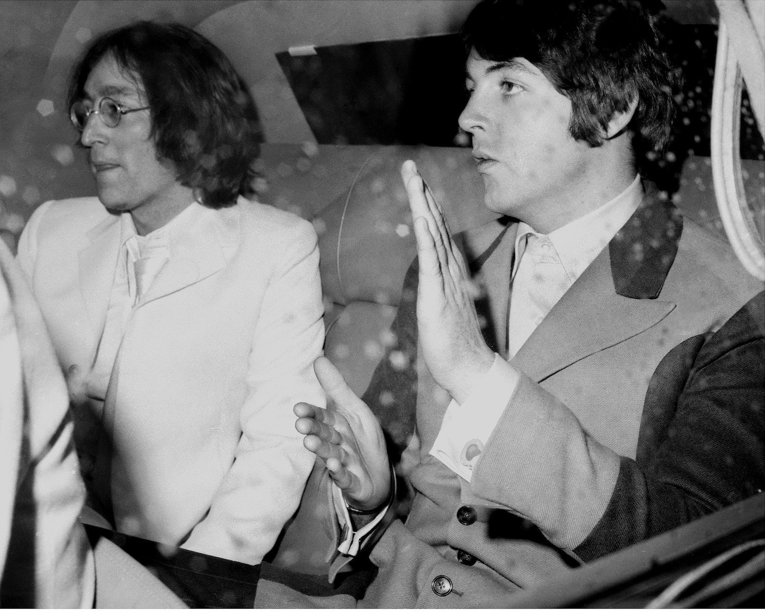 John Lennon and Paul McCartney in the back of a limousine in New York City