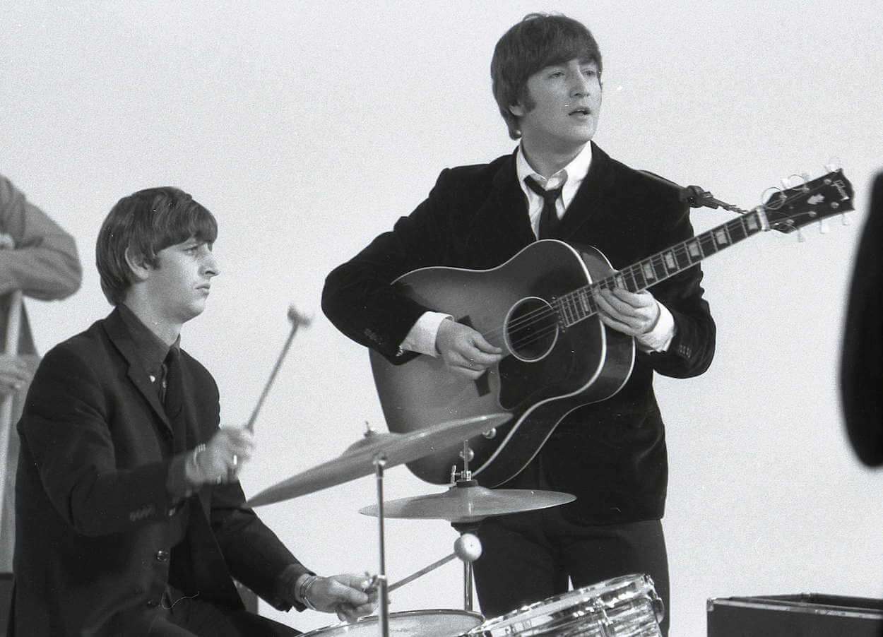 Ringo Starr (left) drumming and John Lennon playing acoustic guitar circa 1964.