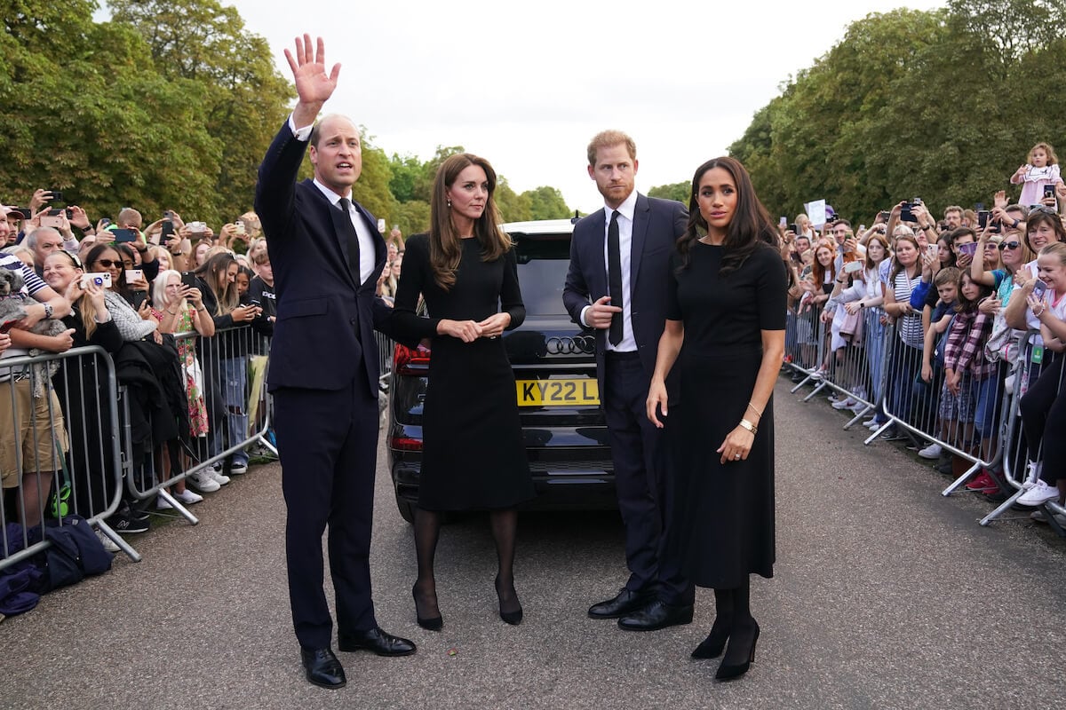 Kate Middleton and Meghan Markle who, according to a body language expert, might've 'deliberately ignored' each other at a 2019 polo match, stand with Prince William and Prince Harry