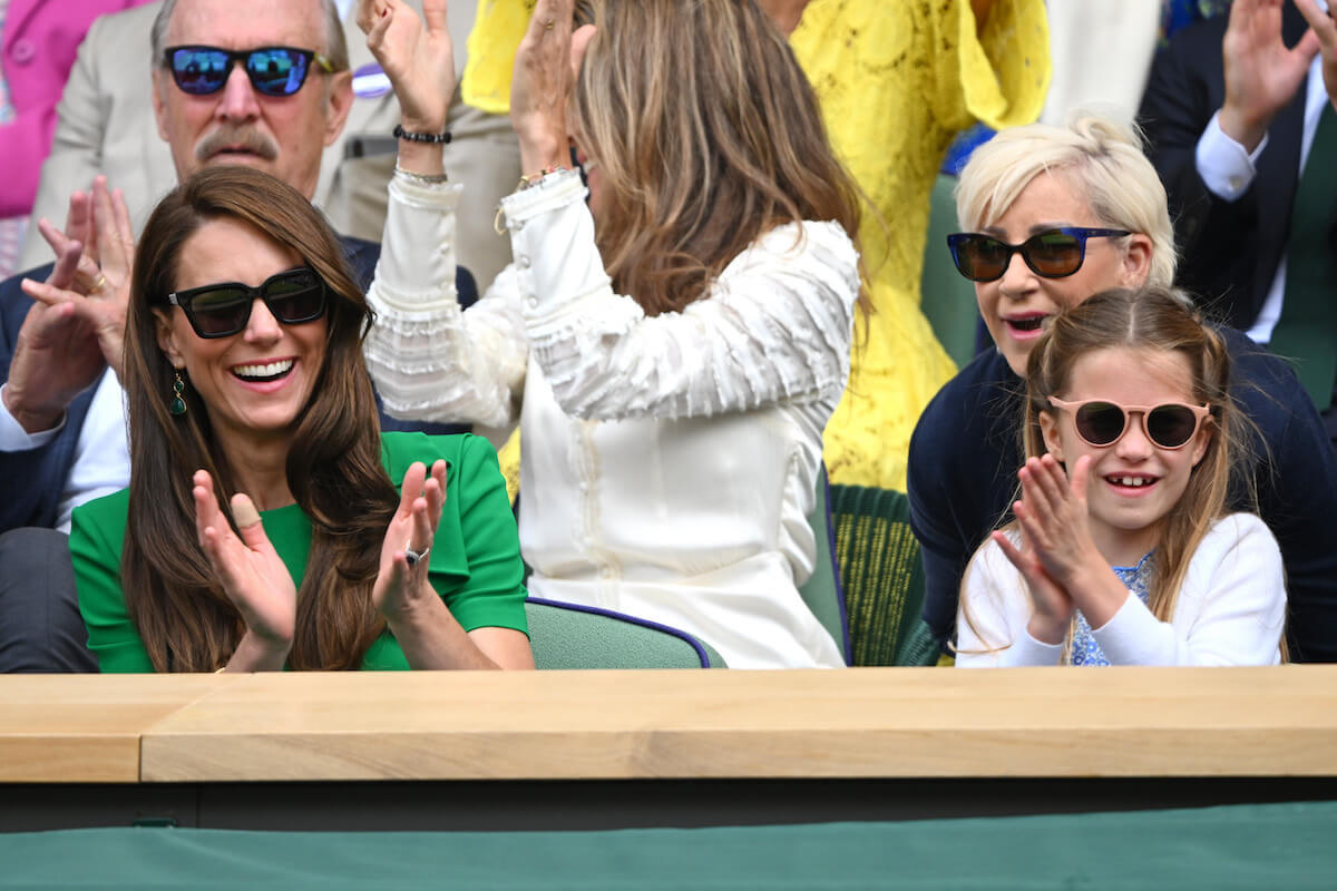 Kate Middleton and Princess Charlotte, who made a 'compelling double-act' at Wimbledon, according to a body language expert, clap