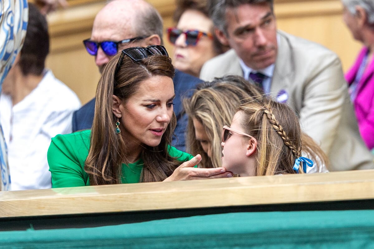 Kate Middleton and Princess Charlotte, who were a 'compelling double-act' at Wimbledon with Prince George and Prince George, look at each other