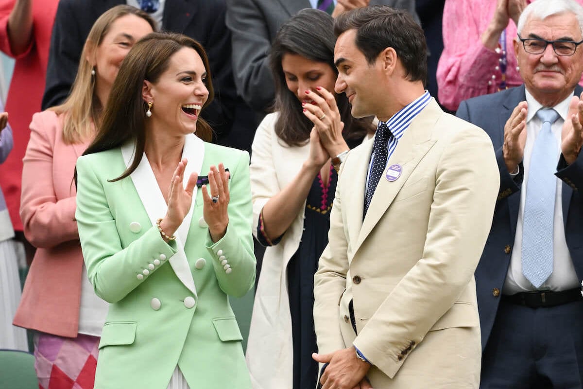 Kate Middleton, who appeared 'overcome' sitting with Roger Federer at Wimbledon, according to a body language expert, claps and looks on