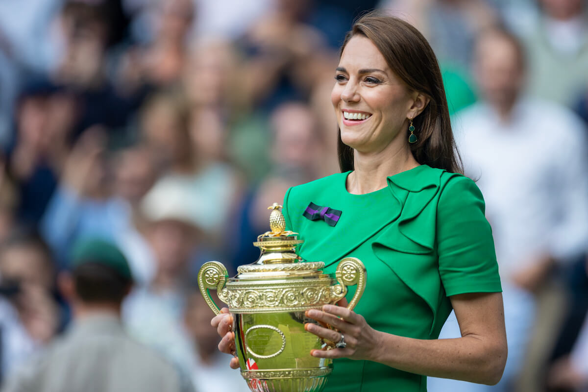 Kate Middleton holds the Wimbledon trophy, where the rules changed in 2003 regarding curtsying and bowing to royalty