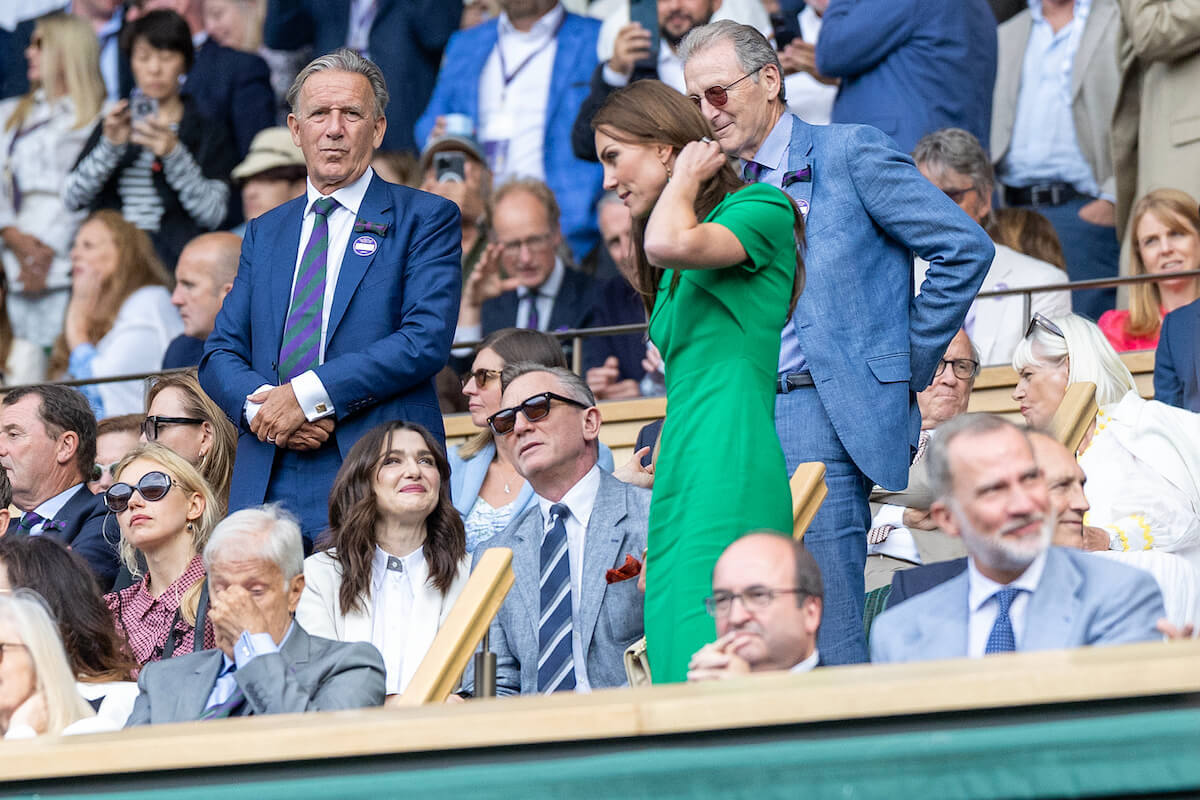 Kate Middleton stands while talking to a seated Rachel Weisz and Daniel Craig in a photo a royal expert called a 'shame'