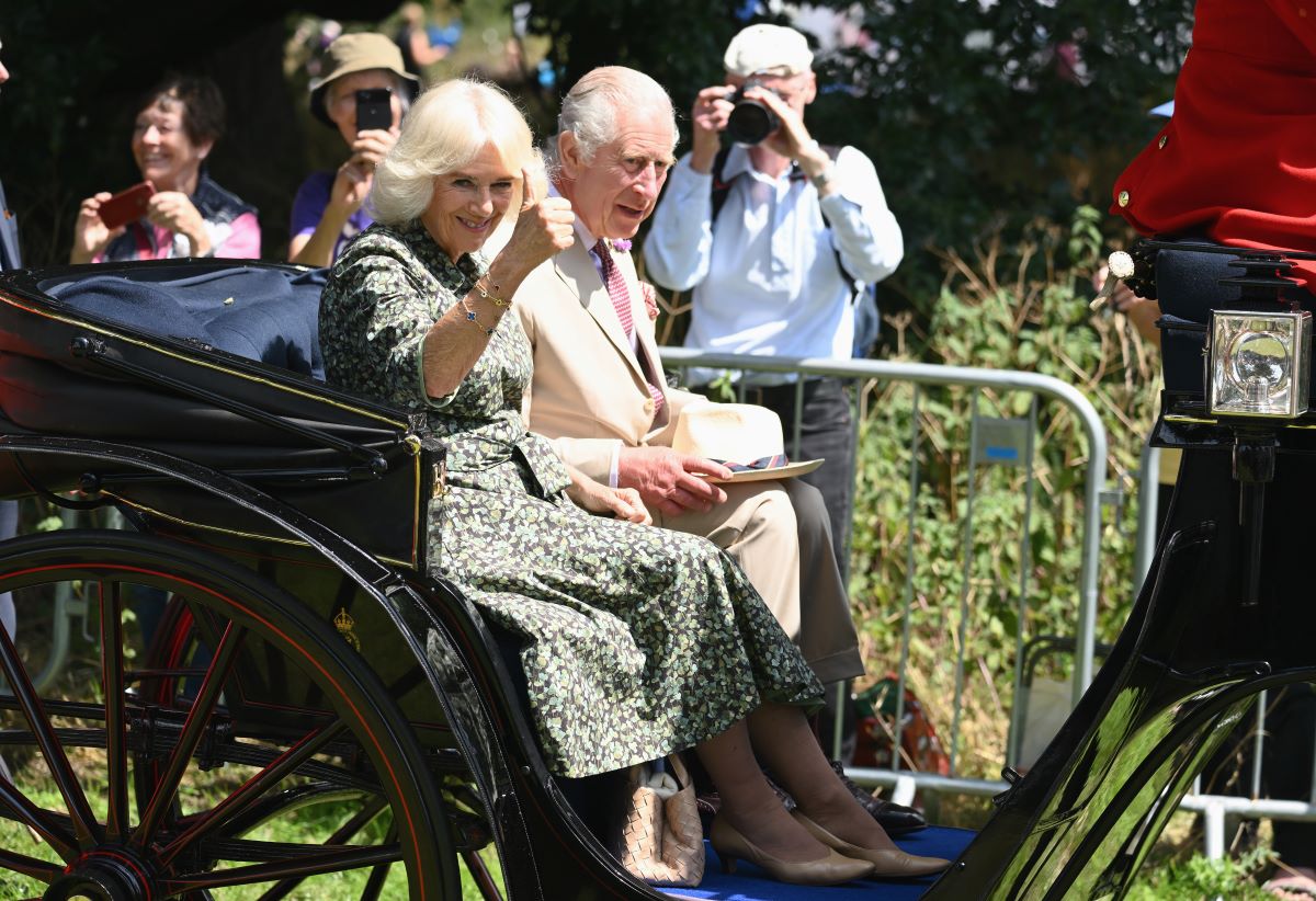 King Charles III and Camilla Parker Bowles (now-Queen Camilla) who a body language expert says were acting like Prince William and Kate Middleton during their visit to Sandringham Flower Show at Sandringham House