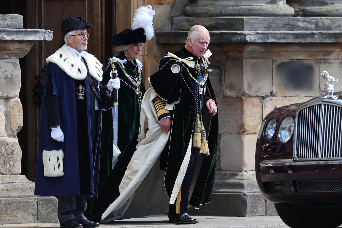 King Charles III, who went into 'husband mode' at his Scottish cornation, according to a bodyl anguage expert, walks with Queen Camilla