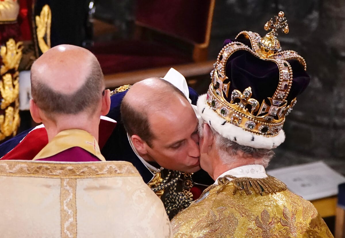 Prince William, Prince of Wales kisses his father, King Charles III, wearing St Edward's Crown, during the King's Coronation Ceremony inside Westminster Abbey on May 6, 2023 in London, England. The Coronation of Charles III and his wife, Camilla