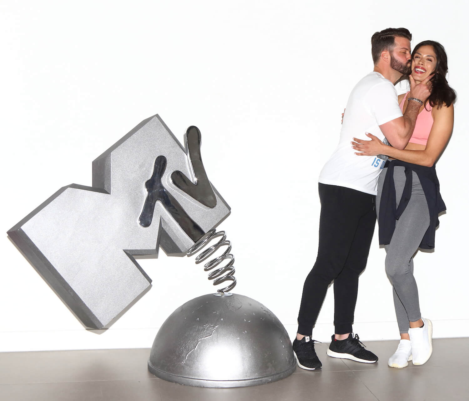 MTV's 'The Challenge' stars Johnny 'Bananas' Devenanzio and Nany Gonzalez next to a chrome MTV sign