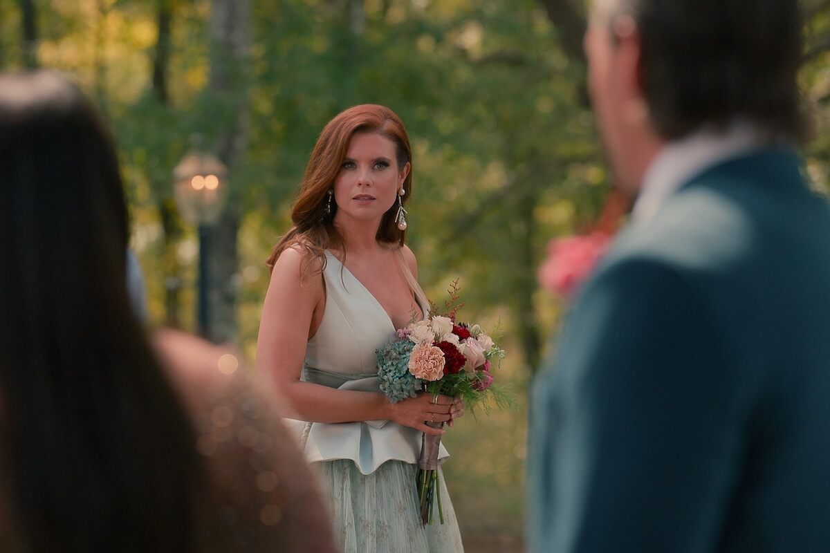 Maddie holding a bouquet and looking confused in 'Sweet Magnolias' Season 3