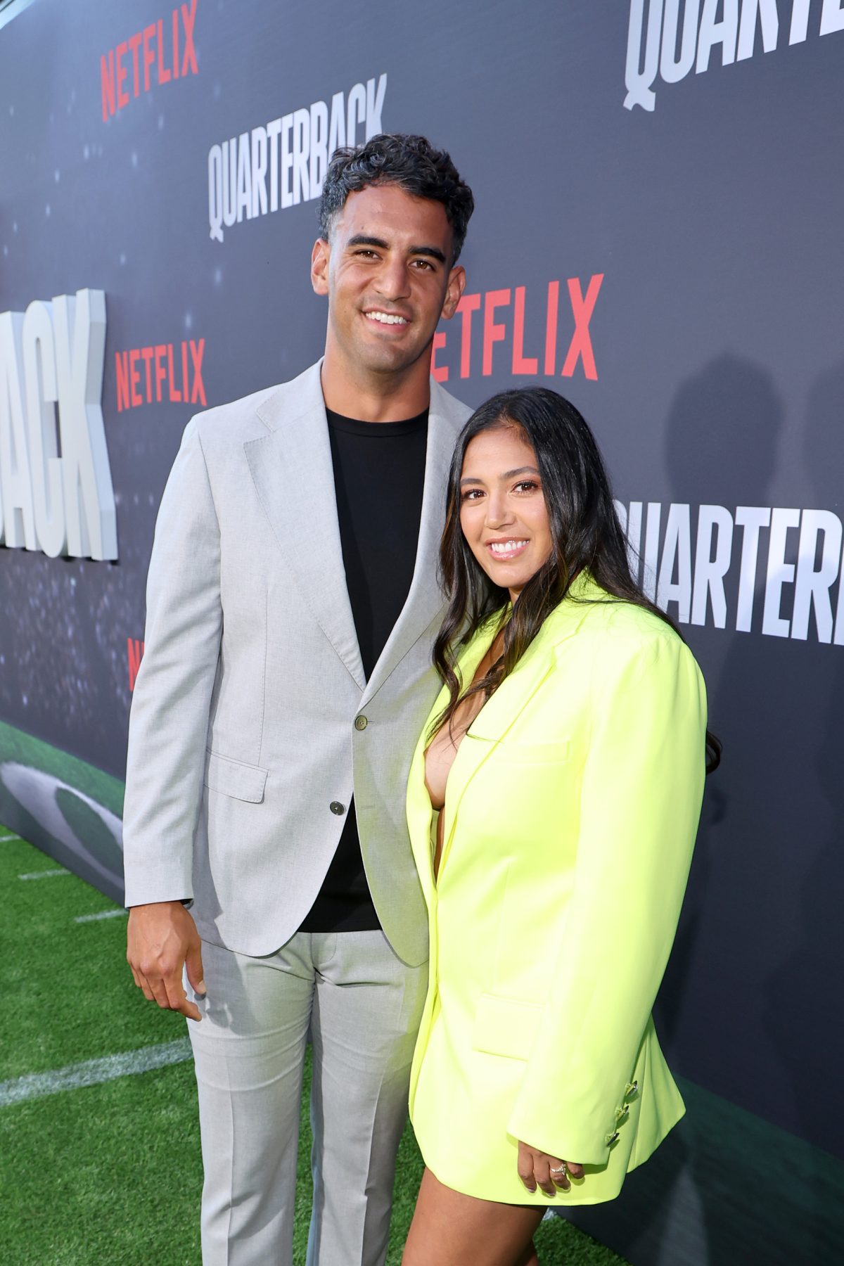 Marcus Mariota and Kiyomi Cook pose for photos at the Netflix premiere of 'Quarterback'