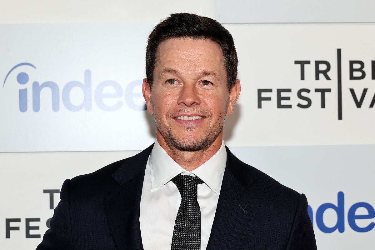 Mark Wahlberg posing in a suit at 'The Golden Boy' premiere.