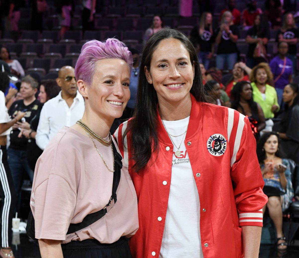 Megan Rapinoe and Sue Bird pose for photos on the court after attending the WNBA All-Star Game