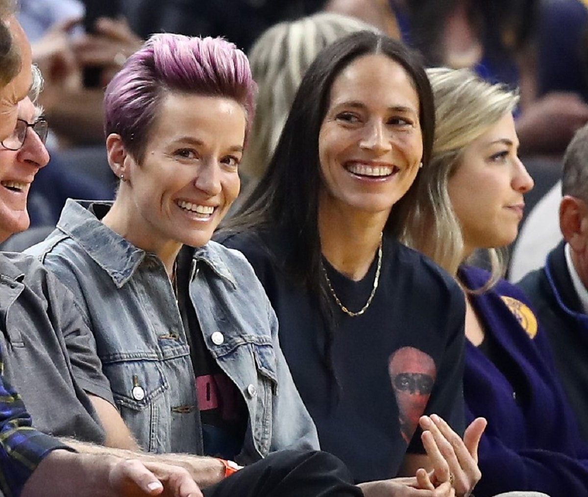 Megan Rapinoe, who is younger than and Sue Bird, watch the Golden State Warriors game together