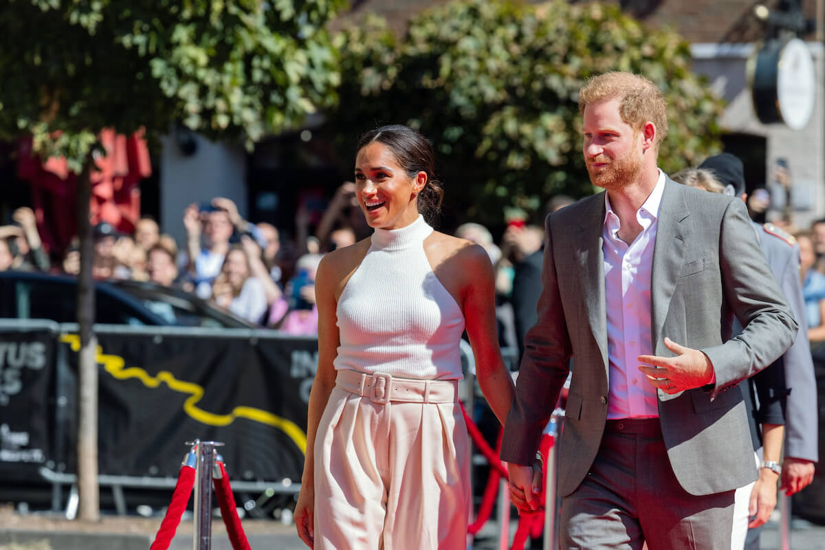 Meghan Markle and Prince Harry attend an event ahead of the 2023 Invictus Games, which the original idea had Prince William reacting with irritation, according to 'Spare'