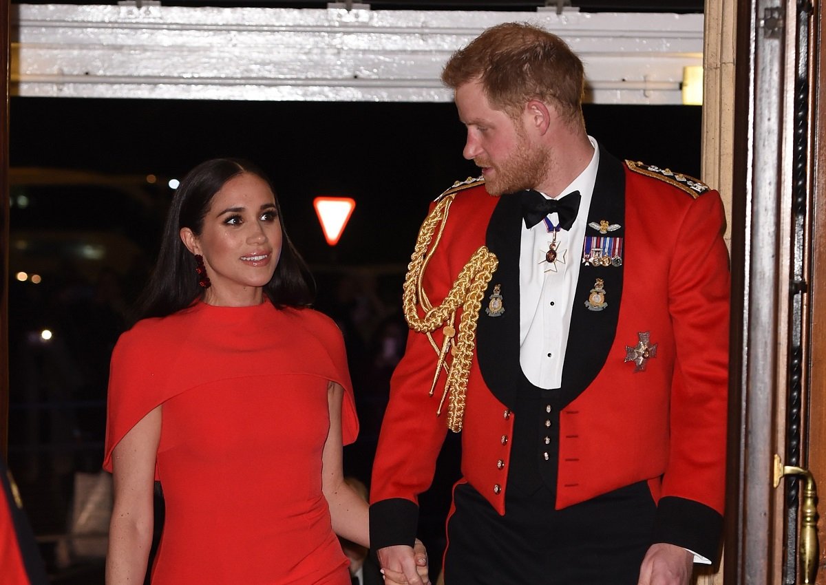 Meghan Markle and Prince Harry, who a commentator claims returning to royal life would be 'humiliating' for them, arrive at London's Royal Albert Hall in 2020 for one of their last royal duties