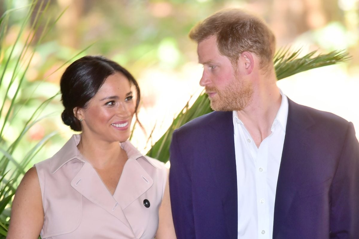 Meghan Markle, who biographers say 'may have already gotten what she needed from Prince Harry' but don't expect him to divorce her, at the British High Commissioner's residence in South Africa